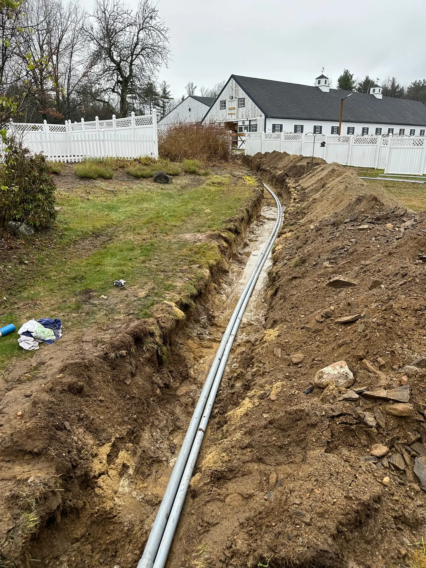 Gas line installation trench with conduit for generator connection by Moore Electric in Haverhill, MA.