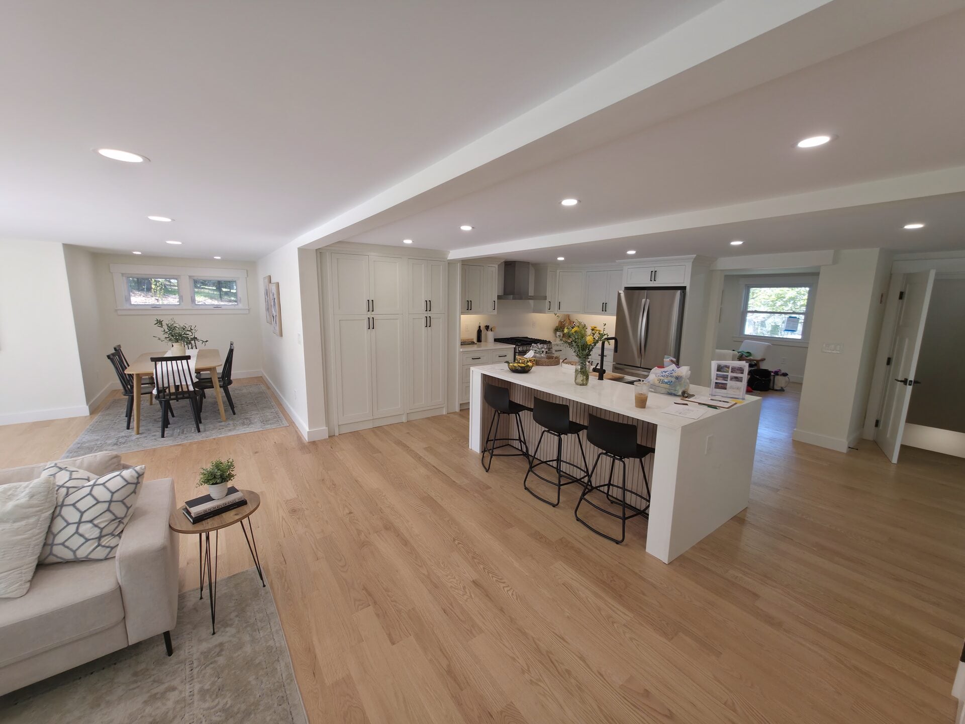 Open kitchen and dining area with modern electrical fixtures, showcasing Moore Electric's residential electrical work.
