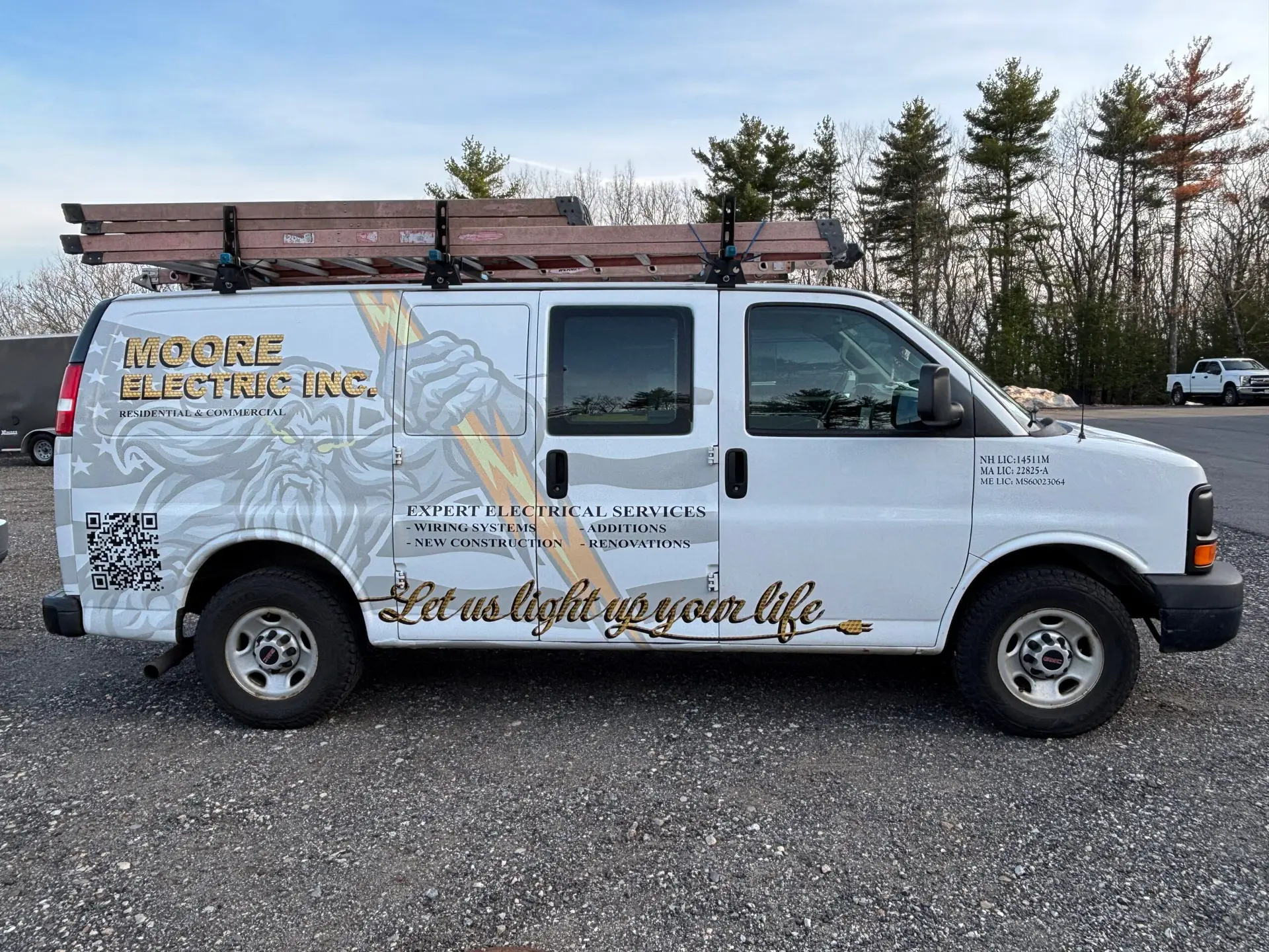 Moore Electric Inc. van with vehicle wrap displaying electrical services and contact information in Plaistow,