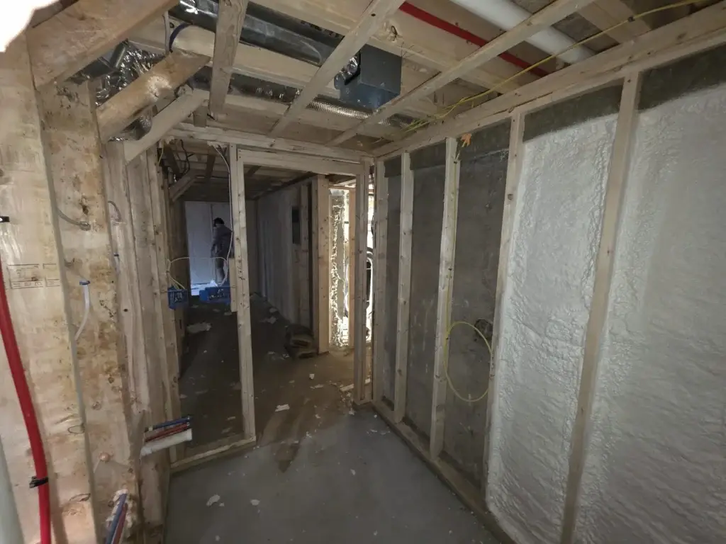 Electrician performing safety inspection in an older home to ensure electrical compliance