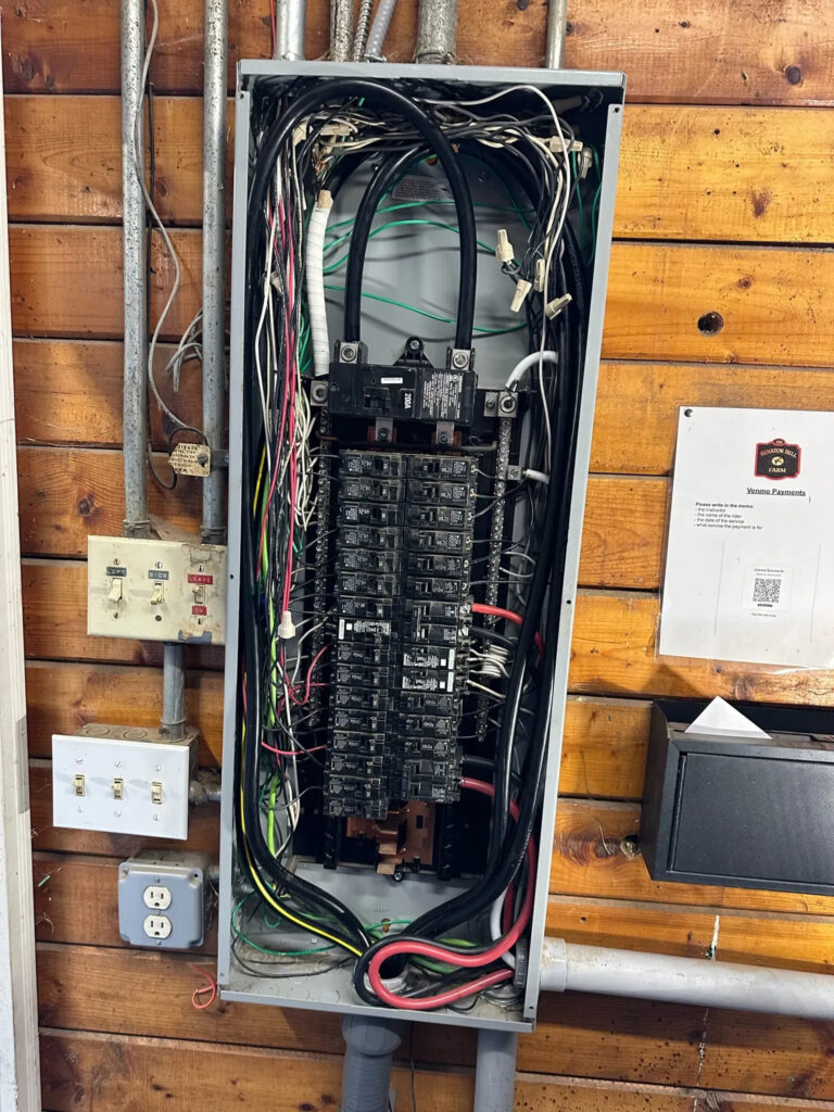 Electrician conducting an inspection of an electrical panel, illustrating upgrade requirements